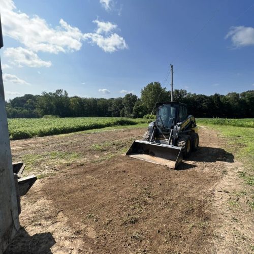Tractor driving on a dirt road at a demolition site